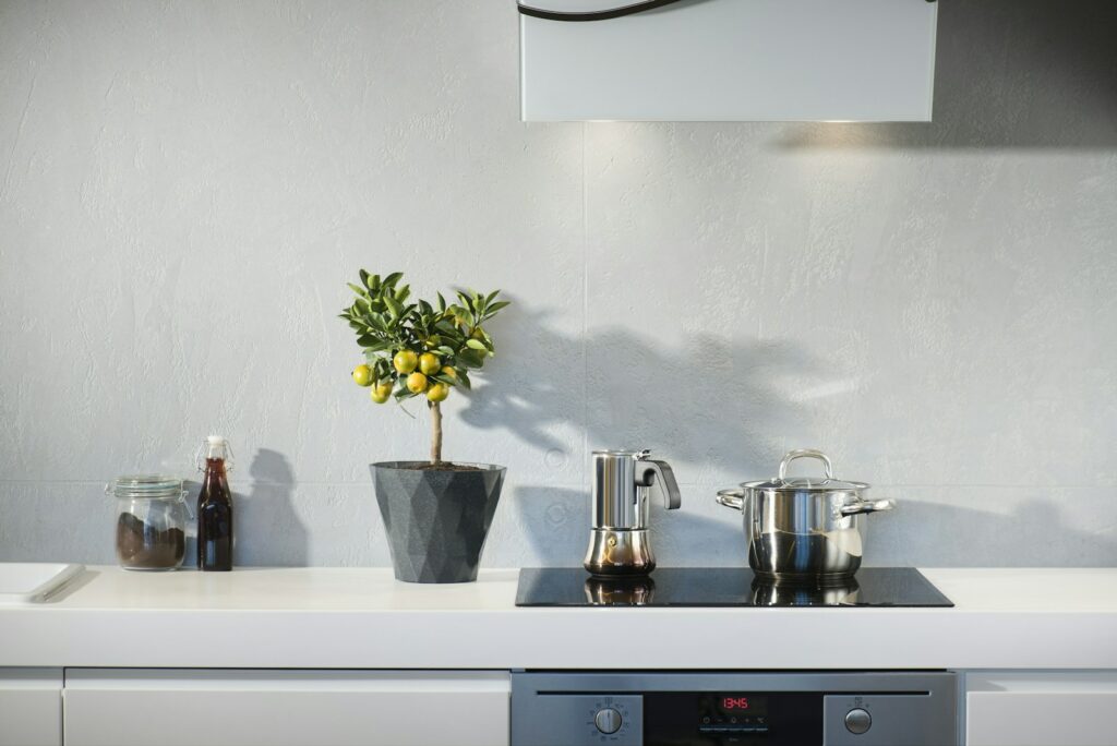 silver pot on top of induction oven